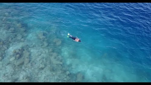Teenage lovers sunbathing on marine resort beach journey by shallow water and white sand background
