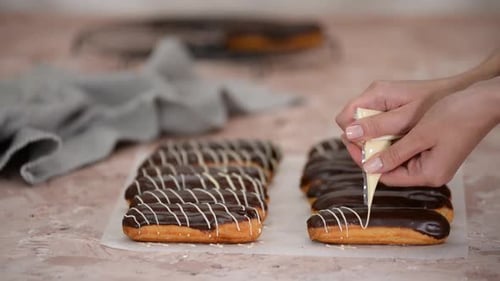 Decorating Chocolate Eclairs with Frosting at Home