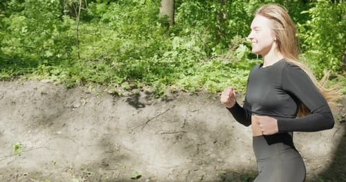 Young Woman Runner Training in Summer Park. Close Up of Fitness Woman Running at Morning Outdoors