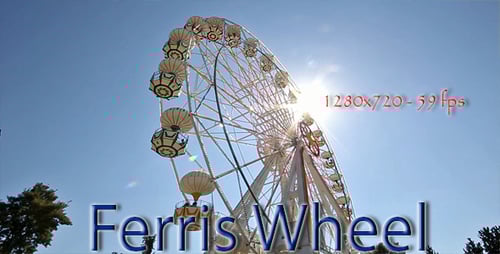 Ferris Wheel Rotating Against Blue Sky Background