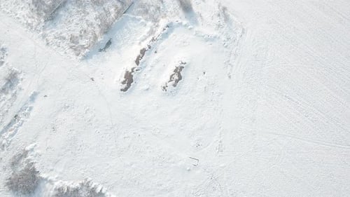 Flying Above AFarmland Covered With Snow