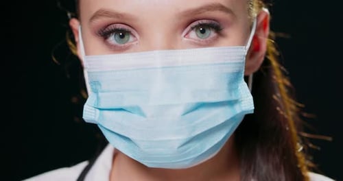 Medical Professional in Mask Looking Directly at Camera