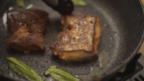 Meat Cooking in Pan With Sage Leaves