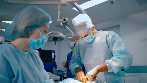Doctor and assistant performing an operation in modern operating room