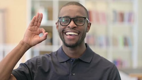 Smiling Man Gives OK Hand Sign in Studio