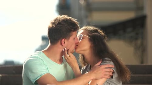 Romantic Couple Kissing on Steps in Urban Setting