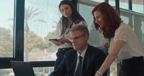 Colleagues team having a business meeting at the office, discussing their new project. Slow motion.