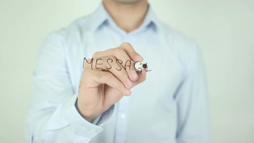 Person Writing the Word Message on Glass