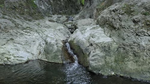 Beautiful water flow cascades 4K 2160p 30fps UltraHD footage - Spring under natural stone bridge 38