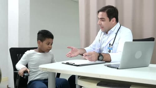 Ein Arzt in einem internationalen Krankenhaus versucht, ein schelmisches Kind in der OP des Krankenhauses zu untersuchen