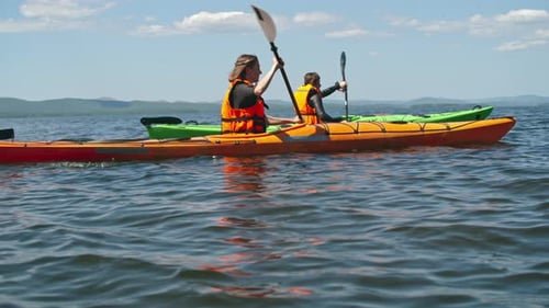 People Kayaking on a Lake in Wilderness