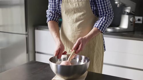 Man Mixing Ingredients in Bowl in Kitchen
