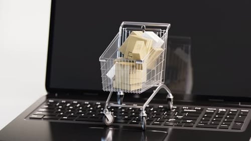 Conceito de compras pela internet. Carrinho cheio de pacotes colocados no laptop aberto.