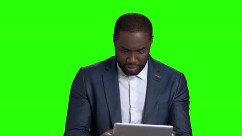 Man In Suit Using Tablet Green Screen