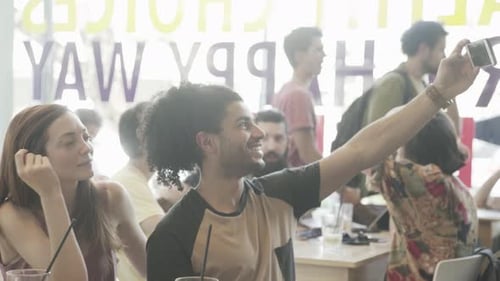 Friends Gather at Urban Cafe Taking Selfies