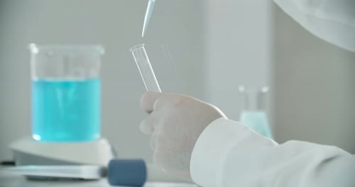 Scientist Using Pipette and Test Tube in Lab