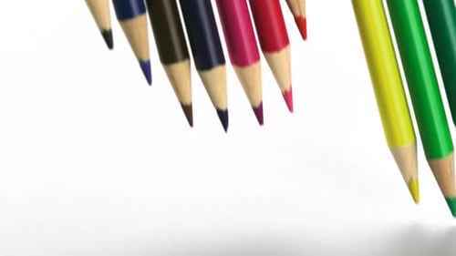 Colorful Pencils Falling on White Background