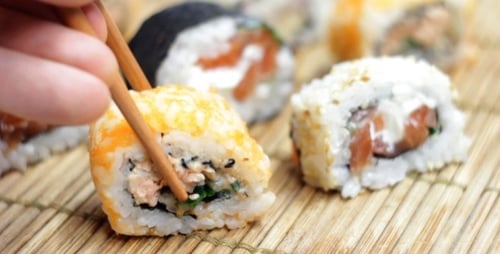 Close-up Sushi Rolls Being Picked Up