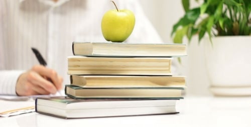 Studying with Apple and Books at Desk