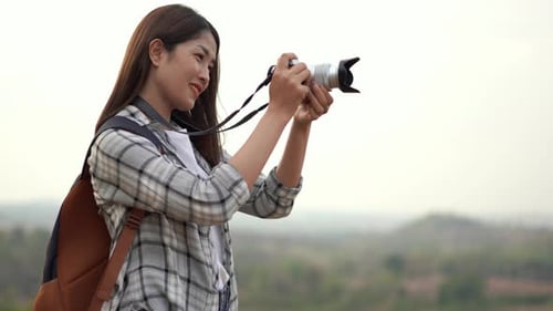 Woman Taking Pictures in a Natural Landscape