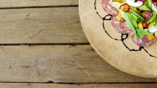 Fresh Salad with Salami on Wooden Board