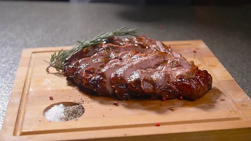 Gourmet Meat Preparation With Rosemary and Seasoning