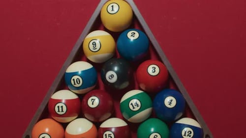 Billiard Balls Racked Up on Red Pool Table