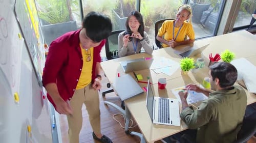 Meeting of UX developer and UI designer brainstorming about mobile app interface workflow design