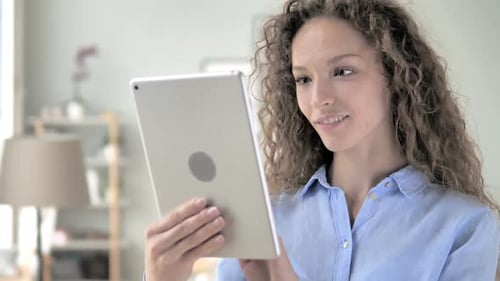 Curly Hair Woman Browsing on Tablet