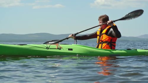Man Kayaking on a Sunny Lake Adventure