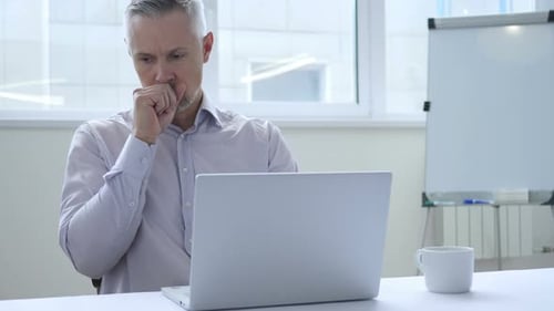Man Working on Laptop in Modern Office