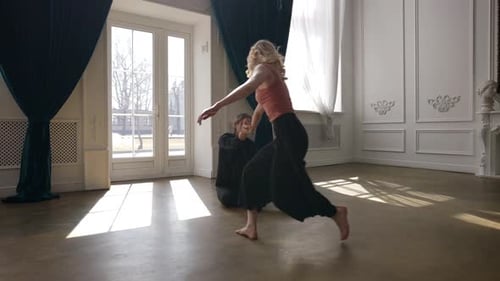Two Dancers Perform Interpretive Dance Together