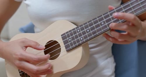 Woman Plays Ukulele
