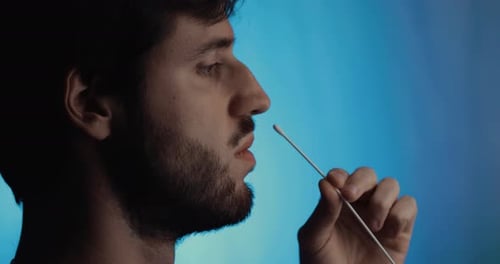 Young Man Performs Nasal Swab Test