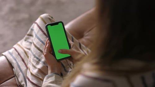 Woman Using a Green Screen Smartphone, Over the Shoulder, Close Up, Copy Space