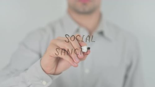 Hand Writing "Social Sanctions" with Marker