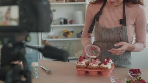 Woman Decorates Cupcakes While Filming Video