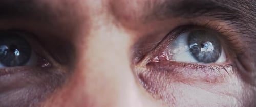 Close up of a man’s blue eyes looking at the sun