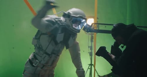 Actor Wearing Spacesuit on Film Set With Green Screen