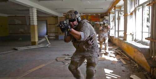 Soldiers Patrol a Destroyed Urban Building
