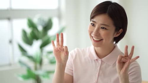 Woman Counting to Ten With Fingers Indoors