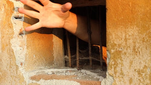 Hoffnungslose Hand hinter Gittern