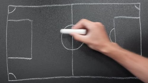 Soccer football field drawing on blackboard with chalk.