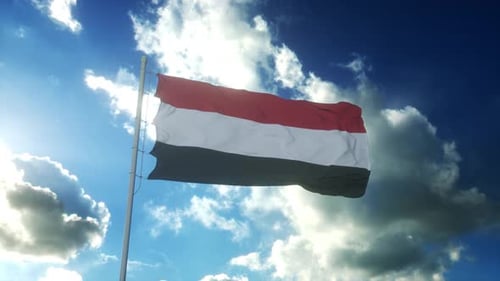 Yemen Flag Waving in the Wind against a Cloudy Blue Sky