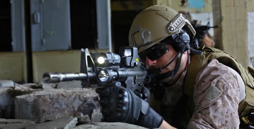 Soldiers With Rifles in War Zone