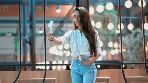 Stylish Woman Taking Selfie in Urban Setting