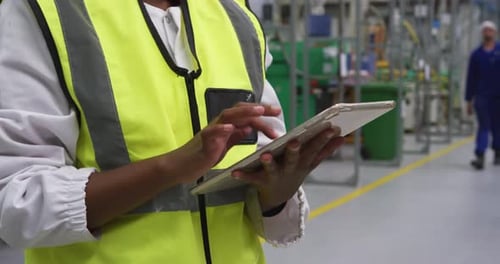 Warehouse female worker using digital tablet