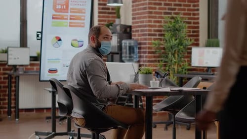 Coworkers Meeting With Face Masks In Office