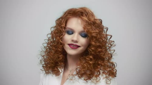 Woman With Curly Red Hair Posing