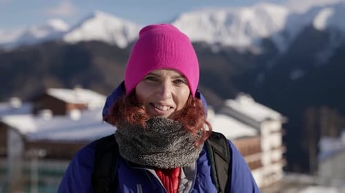 Woman Smiling Outdoors in Snowy Mountain Landscape